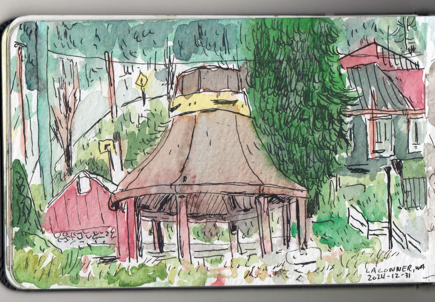 Landscape drawing with watercolor in a sketchbook.